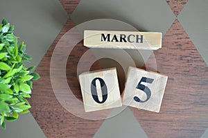 Date of March with leaf on diamond.