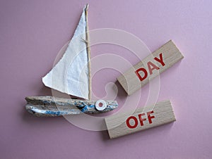 Day off symbol. Concept word Day off on wooden blocks. Beautiful pink background. Business and Day off concept. Copy space