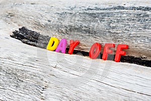 DAY OFF words on wood background