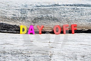 DAY OFF words on wood background