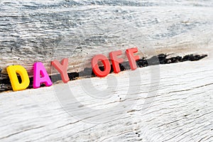 DAY OFF words on wood background