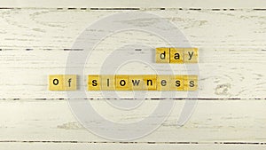 day of slowness.words from wooden cubes with letters