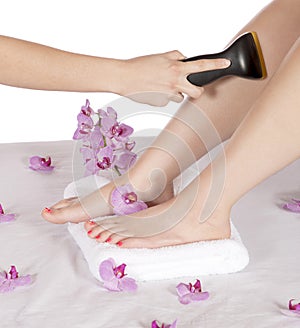 Day spa hair removal by masseuse on leg