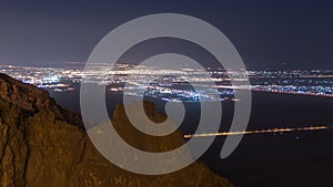 Day to night timelapse with rocks from Jebel Hafeetwith impressive view over the city.