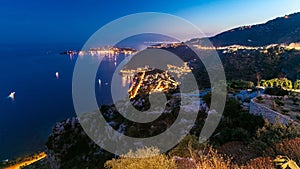 Day to night timelapse view of the Mediterranean coastline of the town of Eze village on the French Riviera