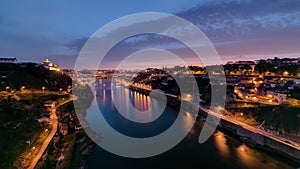 Day to night view of the historic city of Porto, Portugal timelapse with the Dom Luiz bridge