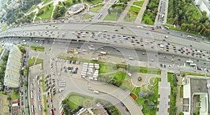 Day traffic on street and overpass bridge. View