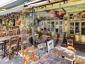 Day view of the empty traditional outdoor seating area of taverns with colorful chairs, tables and vintage decoration