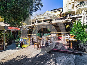 Day view of the empty traditional outdoor seating area of taverns with colorful chairs, tables and vintage decoration