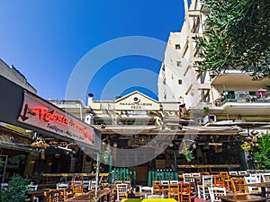 Day view of the empty traditional outdoor seating area of taverns with colorful chairs, tables and vintage decoration