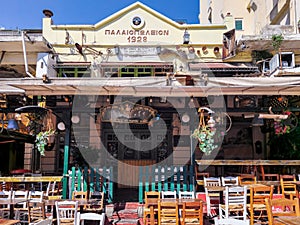 Day view of the empty traditional outdoor seating area of taverns with colorful chairs, tables and vintage decoration