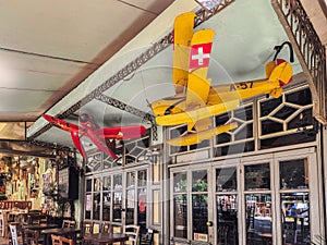 Day view of the empty traditional outdoor seating area of taverns with colorful chairs, tables and vintage decoration