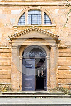 Day view of entrance door to Holy Cross Church in Daventry town centre