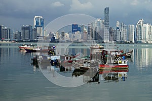 Day view of Panama City Over Panama Bay with skyline and fishing boats on the foreground