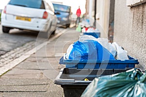 Day view plastice waste refuse bins boxes on British road