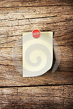 Day of week Sticky note with pin over wooden background