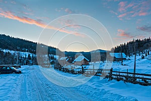 Daybreak sunrise morning winter mountain village snow covered st