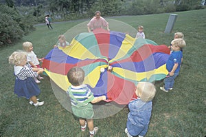 Daycare children playing a parachute game