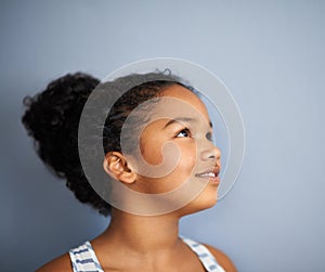 Daydreaming about her future. Cropped shot of a young girl daydreaming.