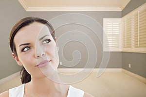 Daydreaming Young Woman in Empty Grey Room