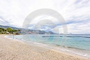 Daylight cloudy day view to beachline with ships cruising on water