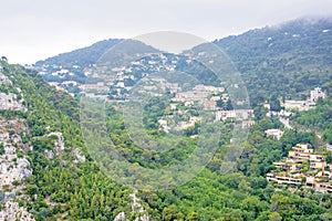 Daylight foggy view to Eze, Cote d`Azur village with medieval ho