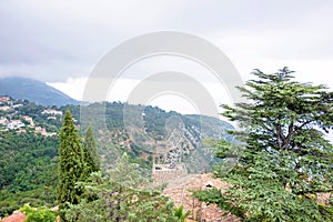 Daylight foggy view to Eze, Cote d`Azur village with medieval ho