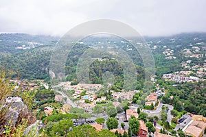Daylight foggy view to Eze, Cote d`Azur village with medieval ho