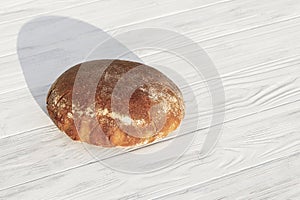 Daylight. rye bread on a white wooden background. Copy space