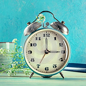 Daylight Saving Time concept, spring forward. A vintage alarm clock