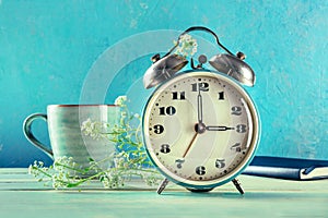 Daylight Saving Time concept, spring forward. A vintage alarm clock