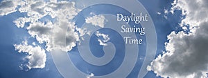 Daylight Saving Time DST. Blue sky with white clouds and clock. Turn time forward +1h photo