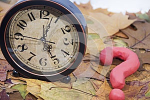Daylight Saving Time. Wall Clock going to winter time. Autumn abstraction.