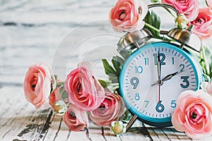 Daylight Savings Time with Clock and Pink Ranunculus Flowers