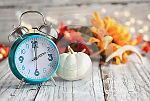 Daylight Savings Time with Clock and White Pumpkin