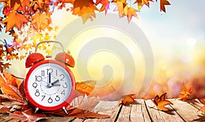 Daylight Savings Time Concept - Clock And Leaves