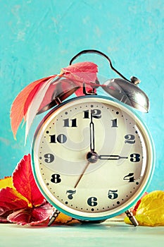 Daylight Savings Time concept, fall back in autumn. A vintage alarm clock