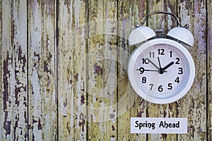 Daylight Savings Time Spring Ahead concept top down view with white clock