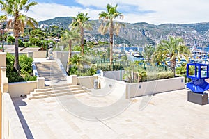 Daylight sunny view to stairs and blue monument near port of Beaulieu-sur-Mer