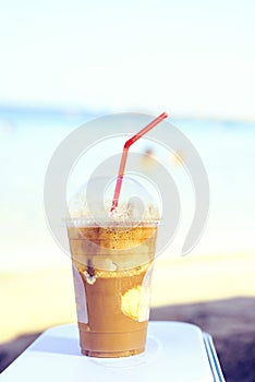 Daylight view to iced latte coffee drink near seashore