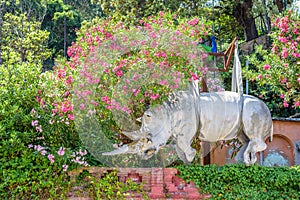 Daylight view to Rhinoceros statue ornated with flowers