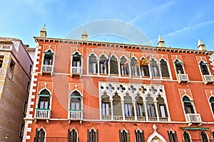 Daylight view to vibrant colorful facade of a building on Riva d