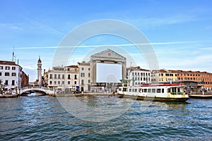 Daylight view from water to Riva degli Schiavoni waterfront buildings and bridge