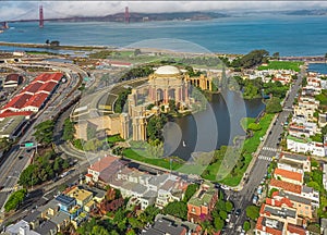 Daytime aerial photo of the Palace of Fine Arts, in San Francisco, California, USA. The Golden Gate Bridge is in the background.