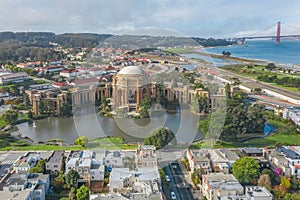 Daytime aerial photo of the Palace of Fine Arts, in San Francisco, California, USA. The Golden Gate Bridge is in the background.