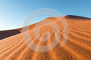 Daytime close-up desert dunes of Erg Chigaga, at the gates of the Sahara. Morocco. Concept of travel and adventure