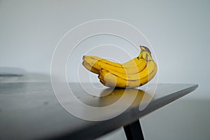 Daytime radiance: banana poised on the sunlit kitchen surface
