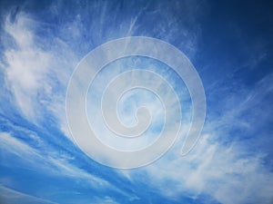 Daytime sky with feathery and layered clouds. Blue sky. Summer sky. Beautiful and whimsical shape of clouds