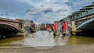 Daytime view of Blackfriars bridge on a cloudy day in London, England