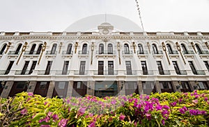 Daytime view of Edificio Luis Manuel Rojas with flower blossom photo